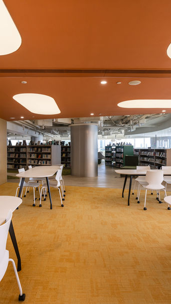 SECONDARY LIBRARY, VSA, Kindergarten Design
Modern library interior designed by MAD Studio, featuring sleek white tables and chairs, vibrant orange ceiling, and built-in bookshelves. The contemporary open space offers a calming atmosphere with natural light and an inviting layout.