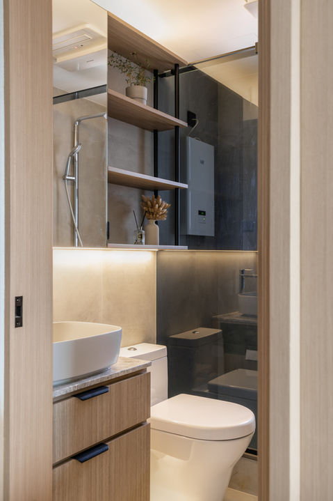 Modern bathroom design featuring sleek wooden cabinetry, a contemporary vessel sink, and elegant glass shower enclosure. The minimalist style is enhanced with open shelves displaying decorative plants and accessories, creating a warm and inviting space. Ideal for luxury home interiors and small bathroom ideas.