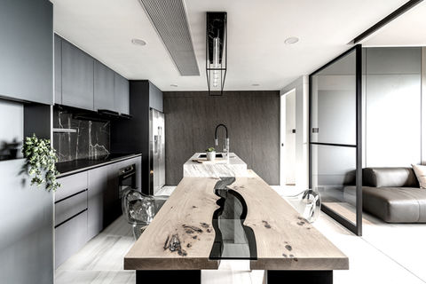 Modern open kitchen, stylish dining room, Long hardwood table with a glass river, marble finish kitchen island, concealed door, industrial pendant, bachelor pad, glass sliding door with black metal frame, stone pattern plastic laminate, white tiles, LVT floor, Hong Kong Parkview