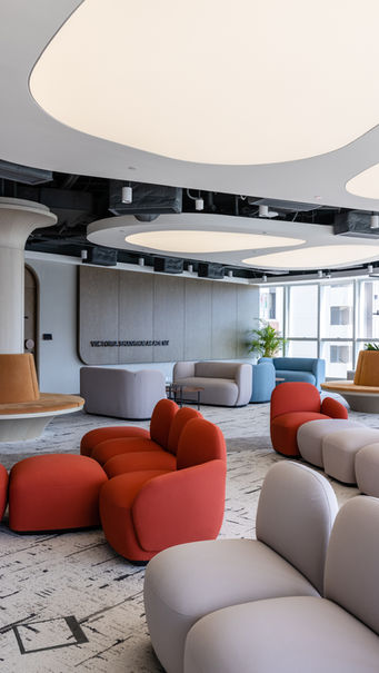 THE QUAY, VSA, Kindergarten Design
Modern interior design by Mad Studio showcasing a stylish office lounge. Features contemporary furniture with vibrant red and neutral-toned modular seating, sleek architectural lighting, and natural elements. Ideal for urban workspace aesthetics.