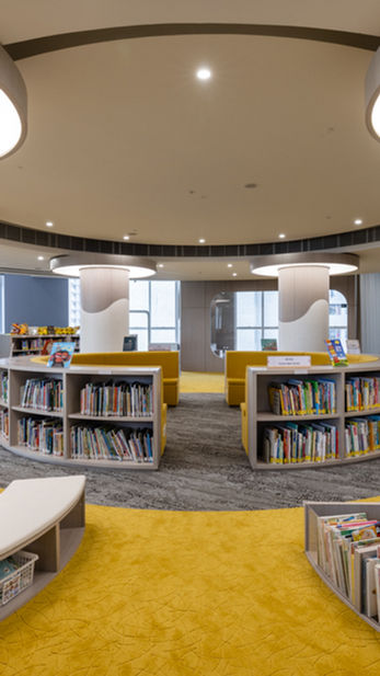 VSA, Commercial Interior Design
Modern children's library interior designed by Mad Studio, featuring circular bookshelves, bright yellow carpet, and soft seating areas. The contemporary design includes large ceiling lights and spacious, open layout. Ideal for creative, educational, and functional spaces. Interior design, library design, modern children's space.