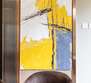 luxury dining room, yellow modern art with bronze metallic frame, gun metal decorative paneal, beige wallpaper, velvet chairs